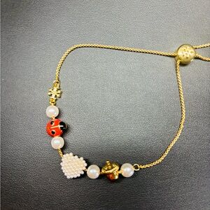 Tory Burch Gold Plated Adjustable Bracelet with Ladybug and Heart Charms. NWT